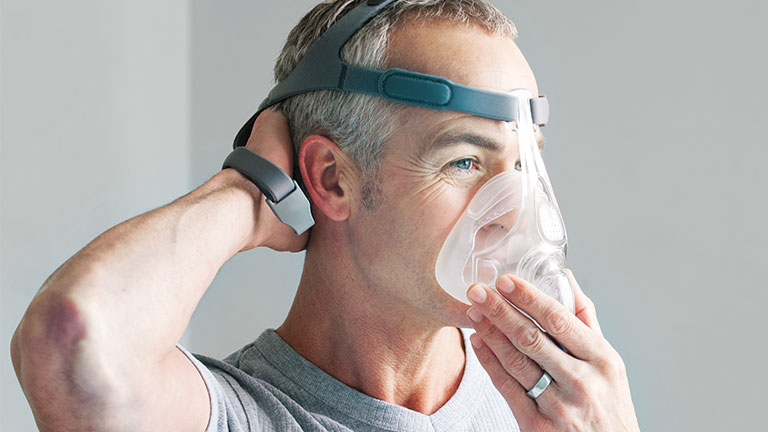 Man fitting CPAP mask